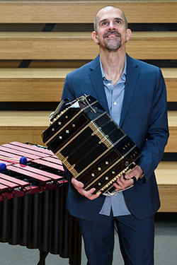 Photo of Ben Thomas with musical instruments